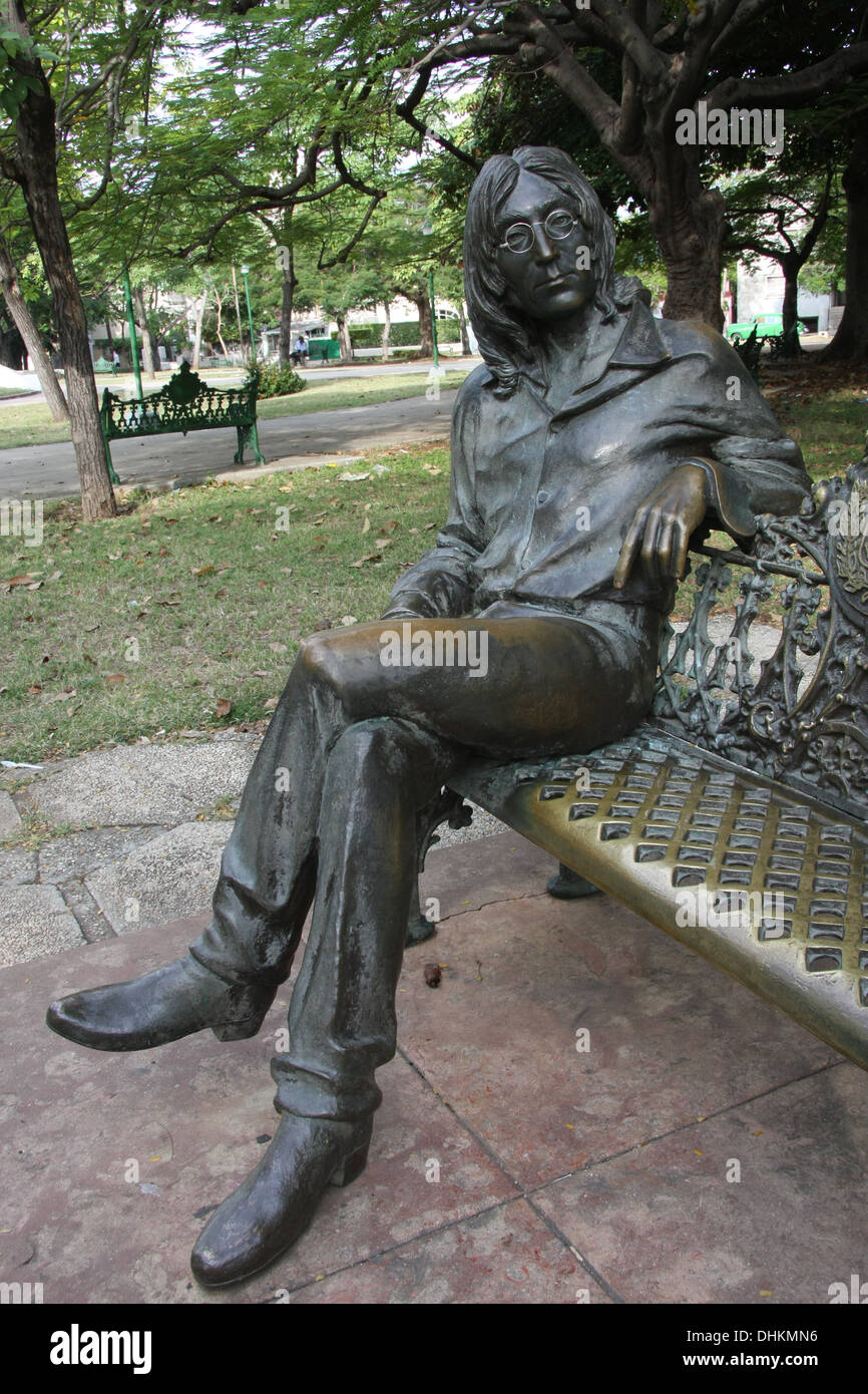 Bronze statue of John Lennon, sitting cross legged on a park bench, Havana, Cuba Stock Photo