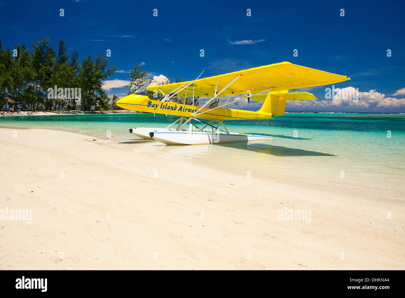 Yellow float plane parked on tropical beach. Roatan, Honduras Stock Photo