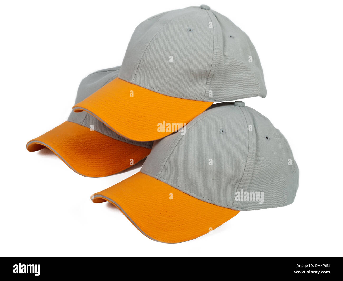 three cool gray baseball caps with orange visor Stock Photo