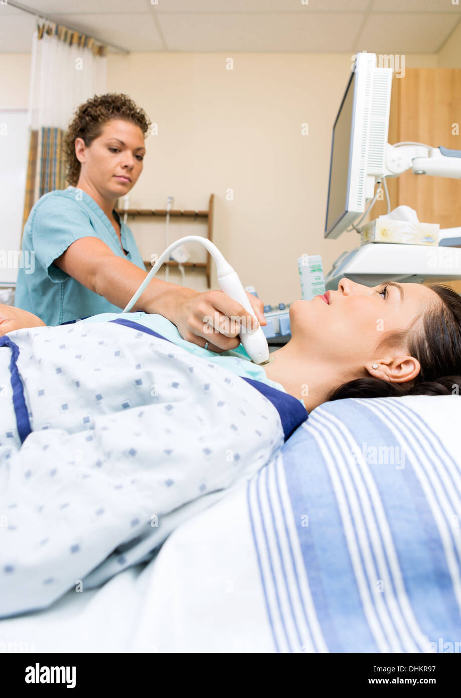 Nurse Performing Ultrasound Neck Scan Stock Photo