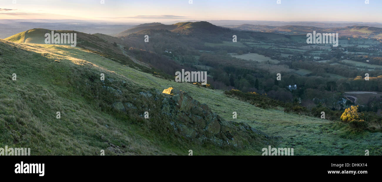 A panoramic photograph taken at sunrise from Pinnacle Hill, Malvern Hills, looking South towards Black Hill, British Camp Stock Photo