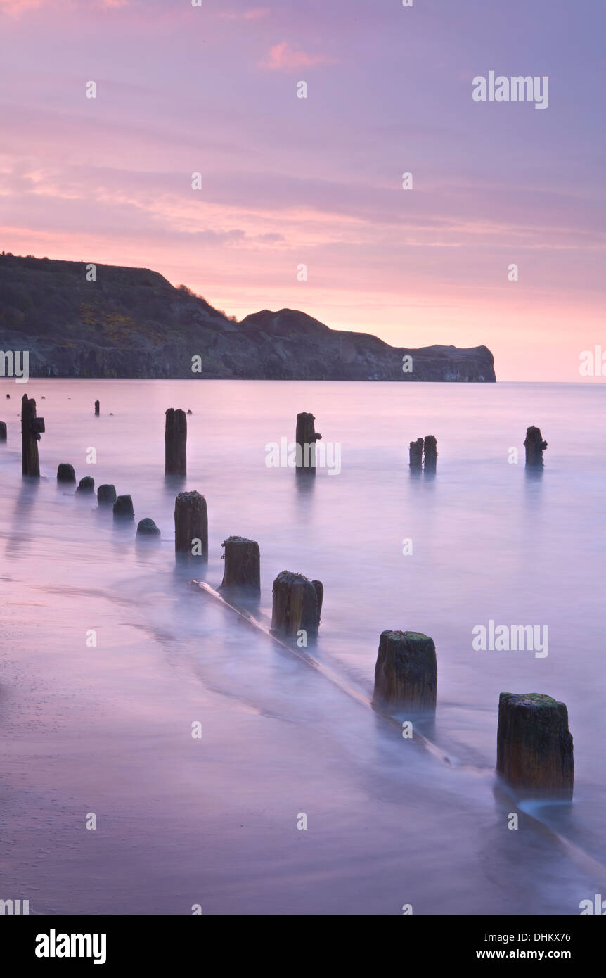 The waves swirl around the groins at Sandsend and Sandsend Ness, North Yorkshire, at high tide. Stock Photo
