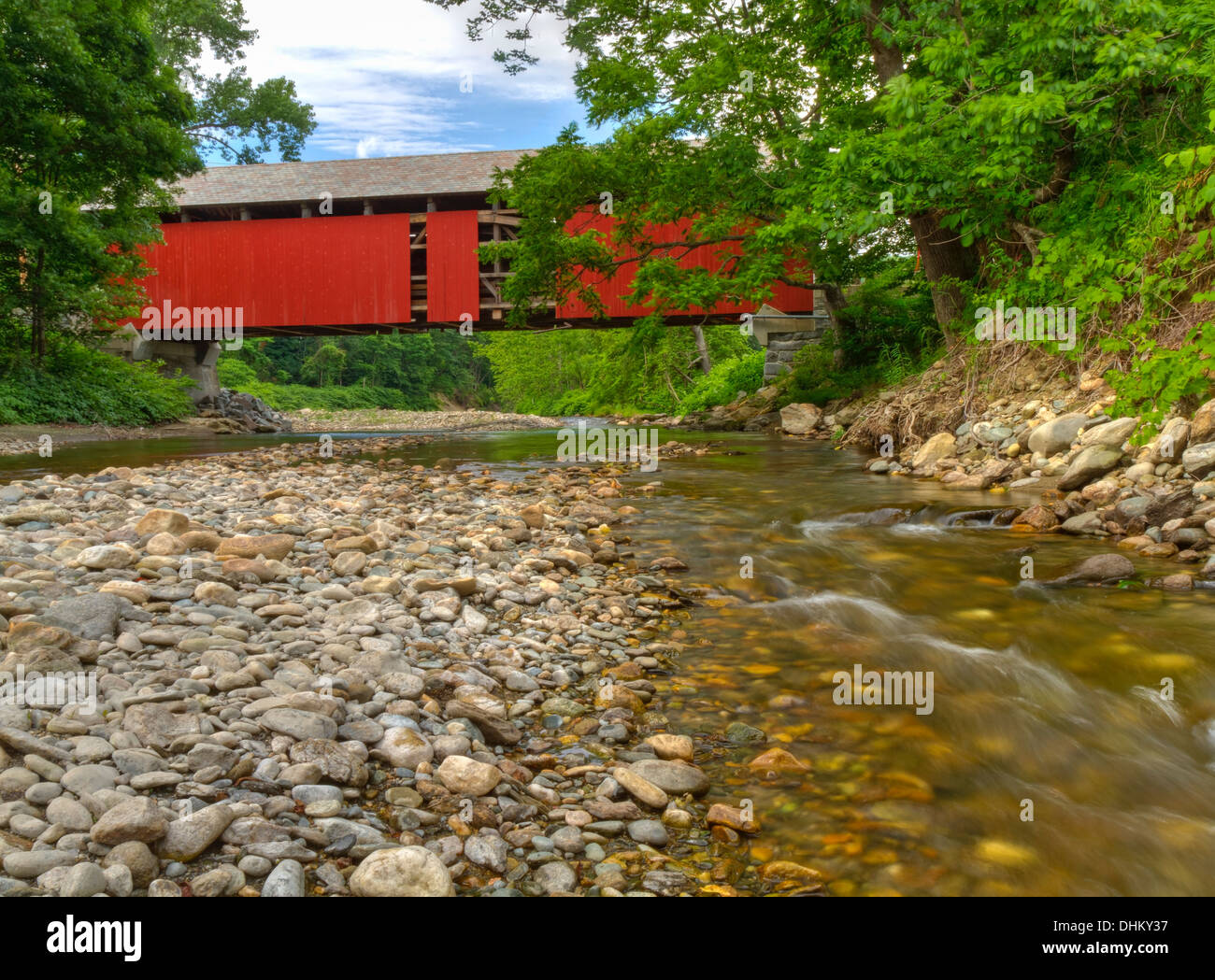 A partially exposed covered bridge on the North River near Colrain, Massachusetts seen from downstream Stock Photo
