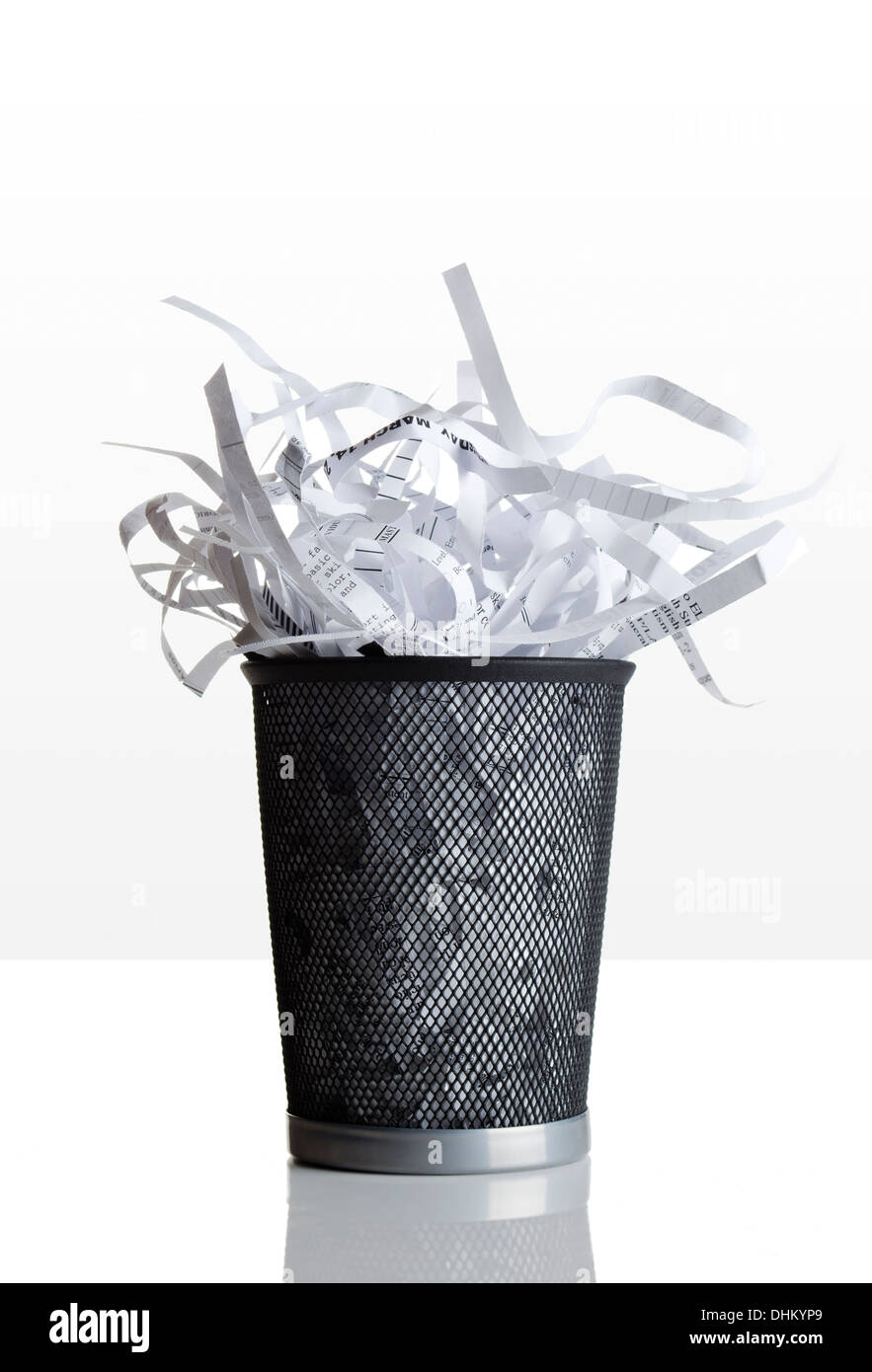 Trashcan full of shredded paper Stock Photo