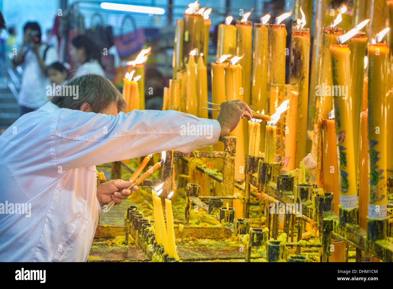 lighting candles for good luck at the Vegetarian Festival in Bangkok