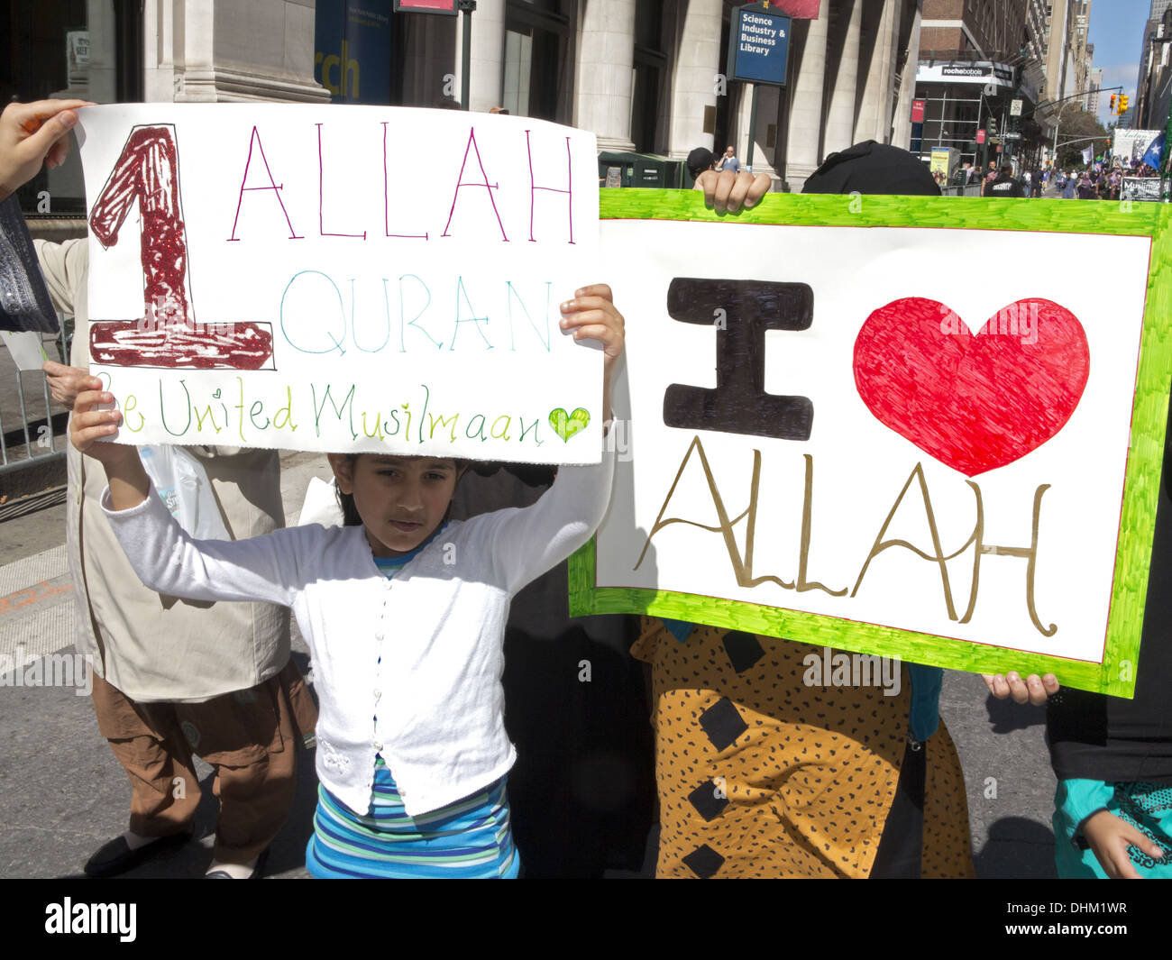 Annual Muslim Day Parade, New York City, 2013. Women cover their faces with signs that extol the virtues of Allah. Stock Photo
