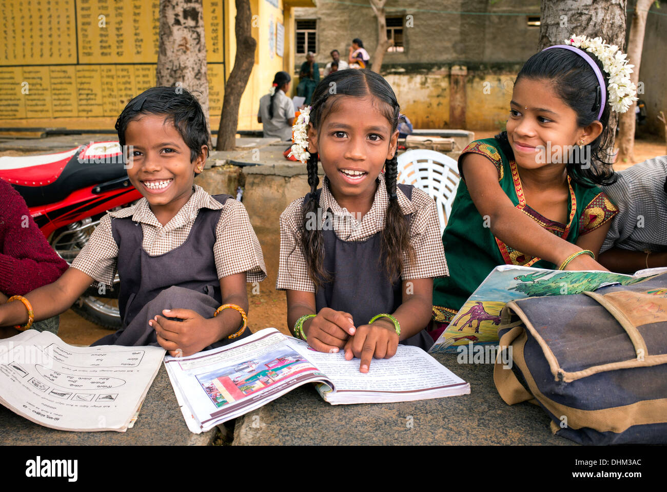 Rural Indian village school girl writing in books in an outside class. Andhra Pradesh, India Stock Photo