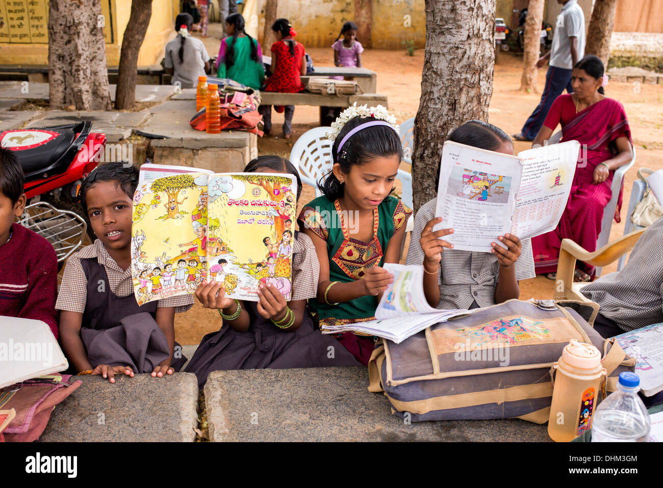 Rural Indian village school girl writing in books in an outside class. Andhra Pradesh, India Stock Photo
