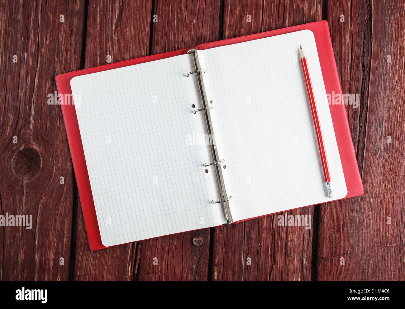 Open blank notepad  with a pencil laying on old wooden table Stock Photo