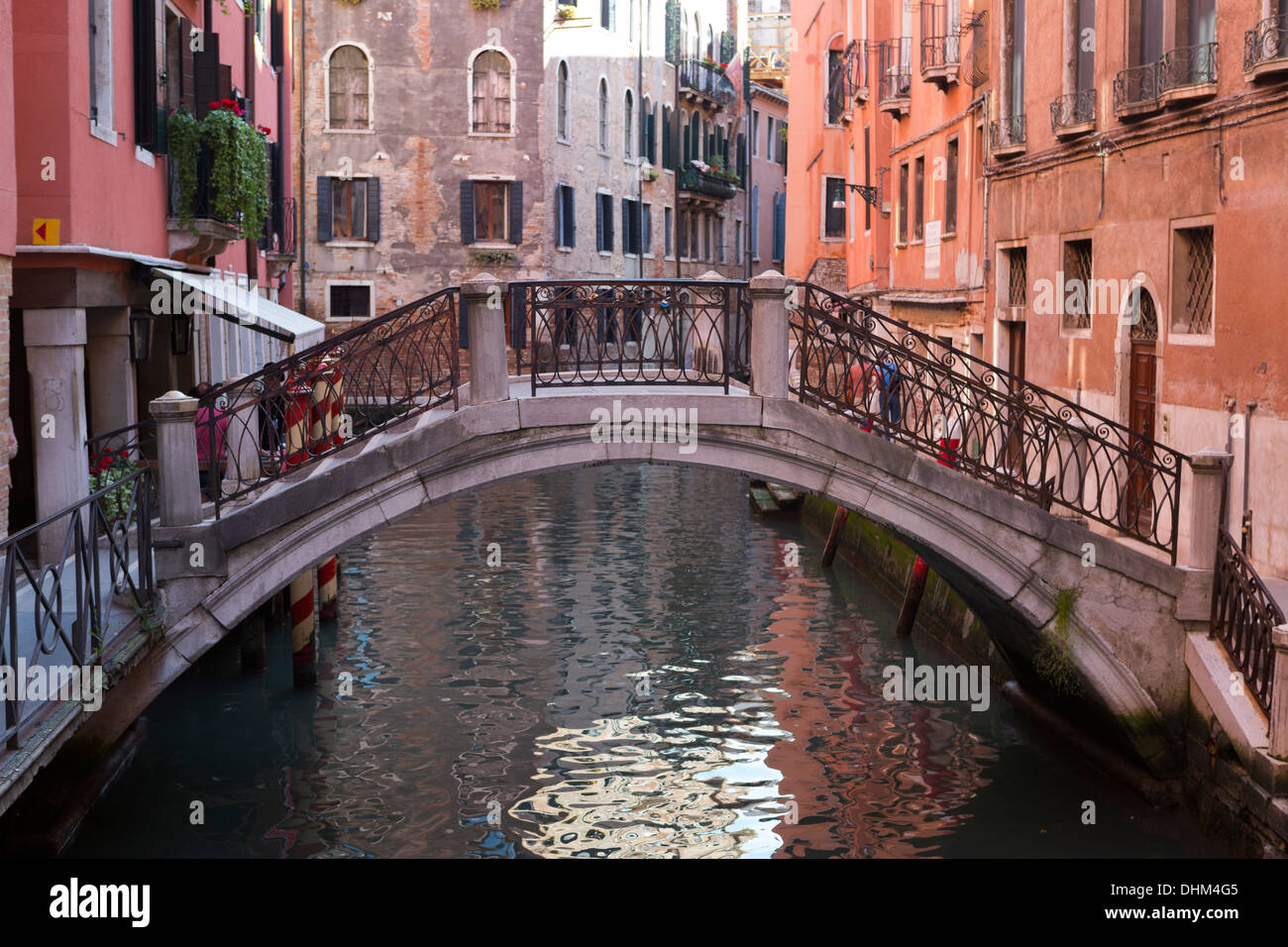 Beautiful little bridge over a small canal lined with colorful buildings in Venice, Italy Stock Photo