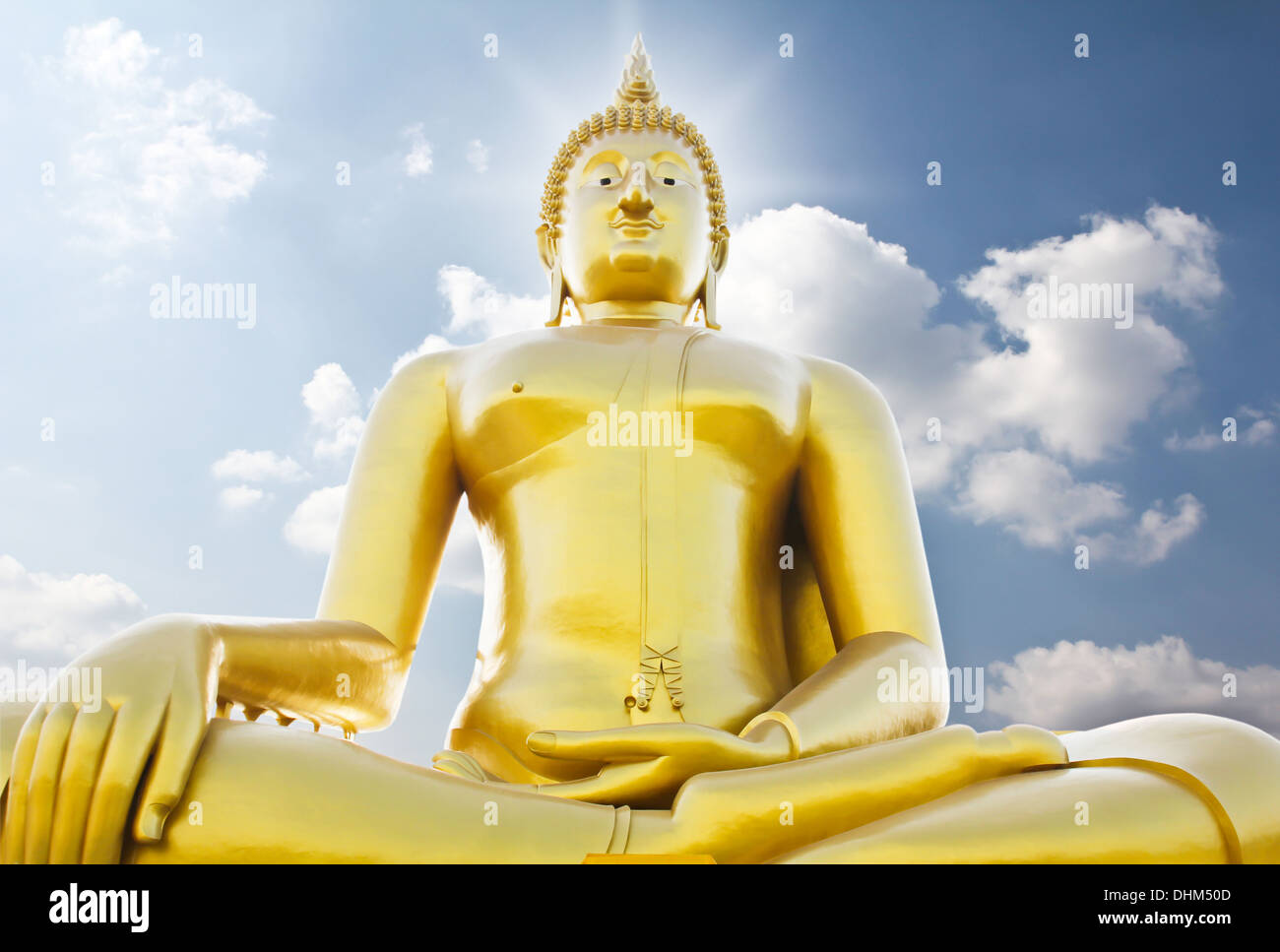 Big golden buddha statue against sky Stock Photo