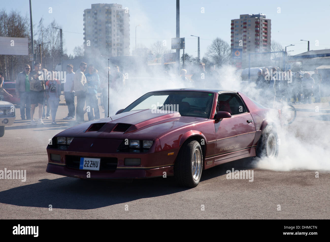 Old American sports car doing tyre burnout with lots of smoke Stock Photo