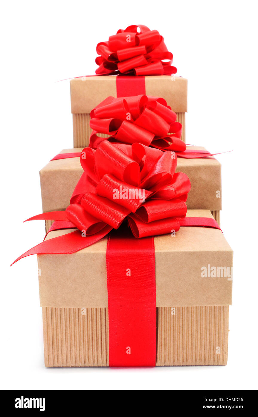 a pile of gifts with red ribbon bows on a white background Stock Photo