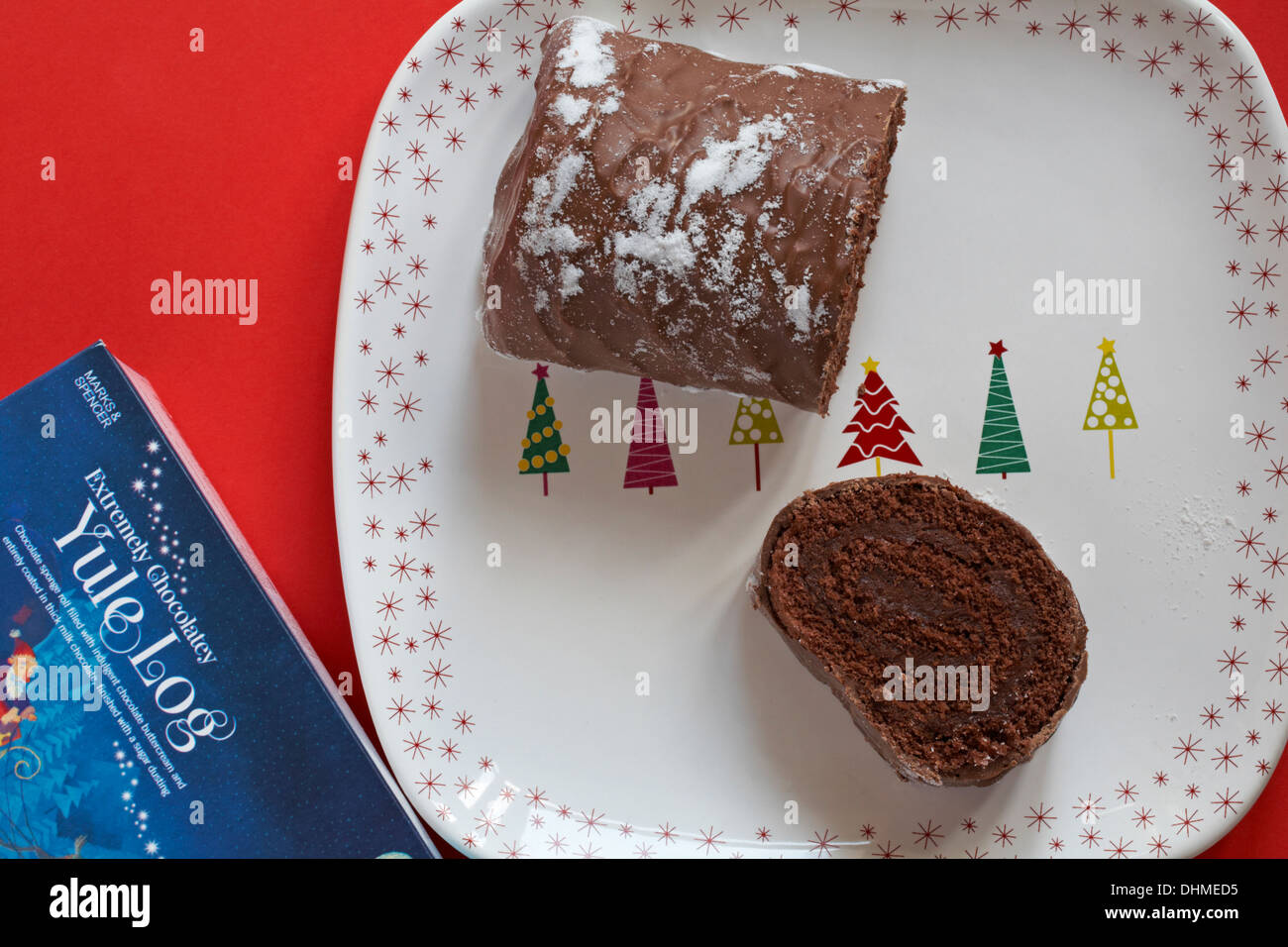 Marks & Spencer Extremely Chocolatey Yule Log cut up on festive plate Stock Photo