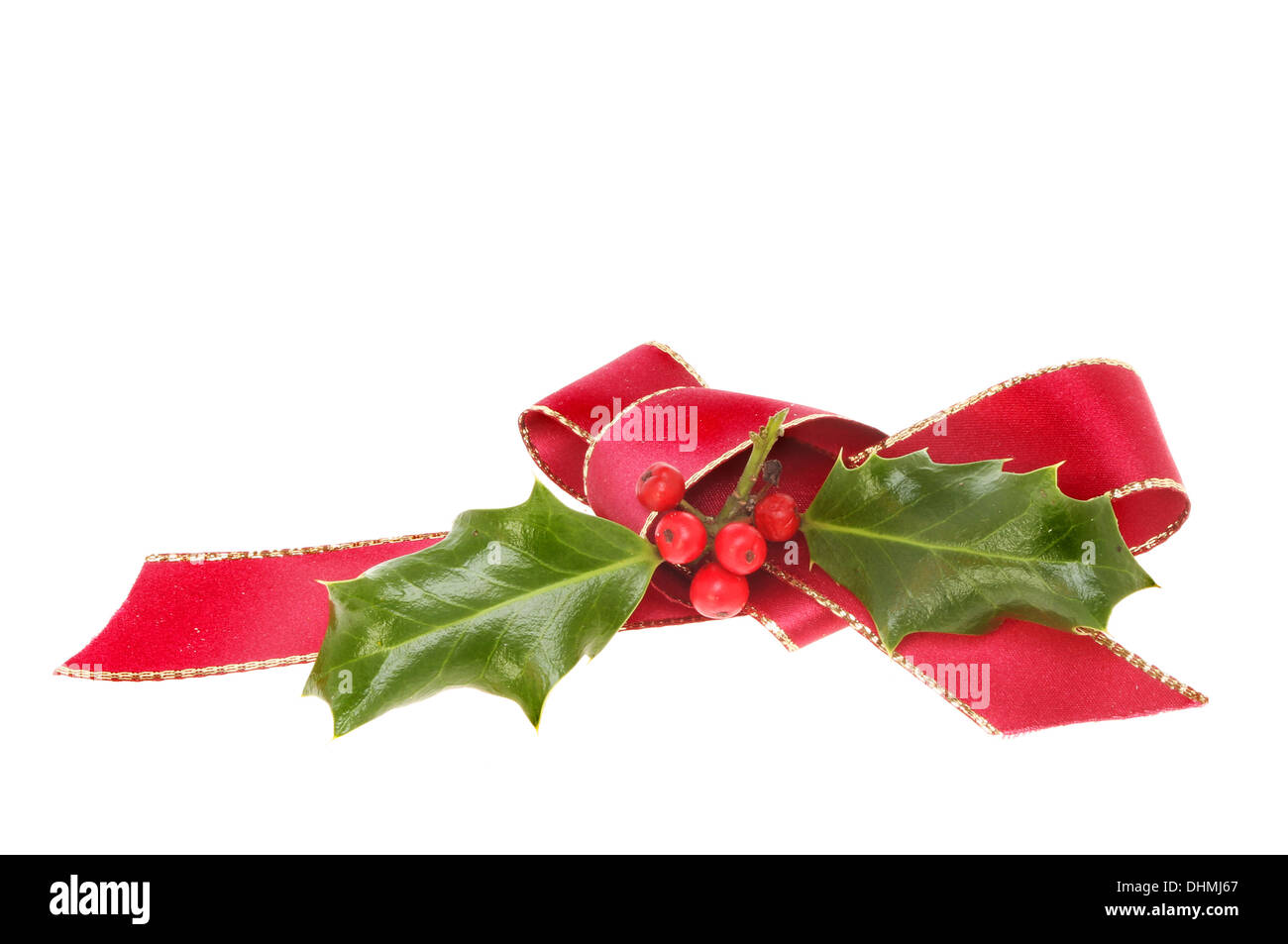 Red ribbon bow and holly as Christmas motif isolated against white Stock Photo