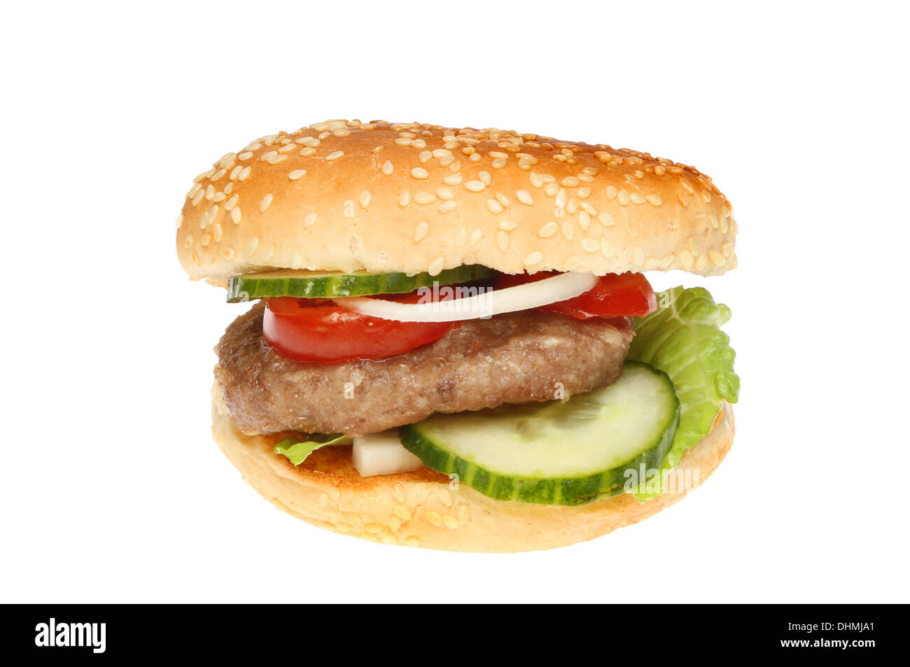 Burger with salad in a sesame seeded bun isolated against white Stock Photo