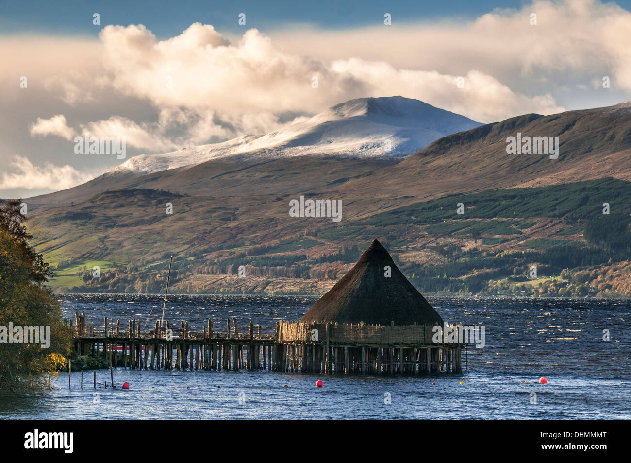 The Scottish Crannog Centre on Loch Tay in Perthshire. Snowy Ben Lawers in the background Stock Photo