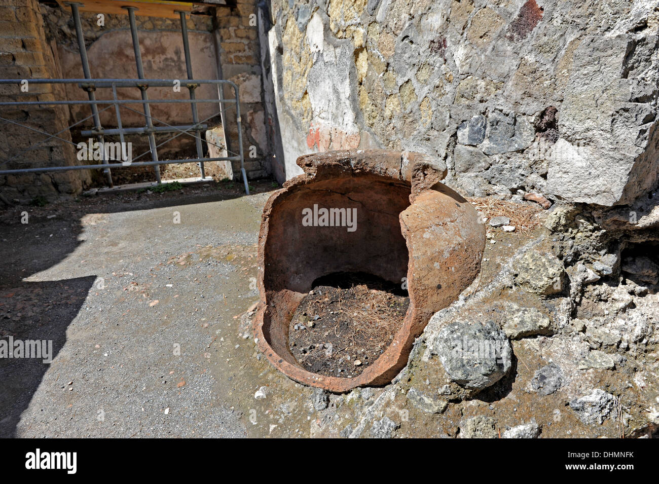 A broken storage jar used for serving food lies in the ruins of Herculaneum Stock Photo