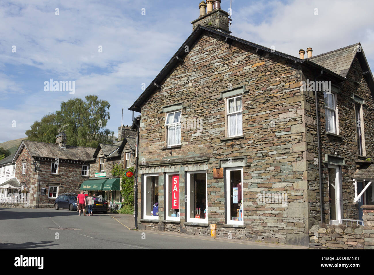 'Red Lion Square with the foreground dominated by Edge of the World' outdoor clothing shop in Grasmere, Cumbria Stock Photo