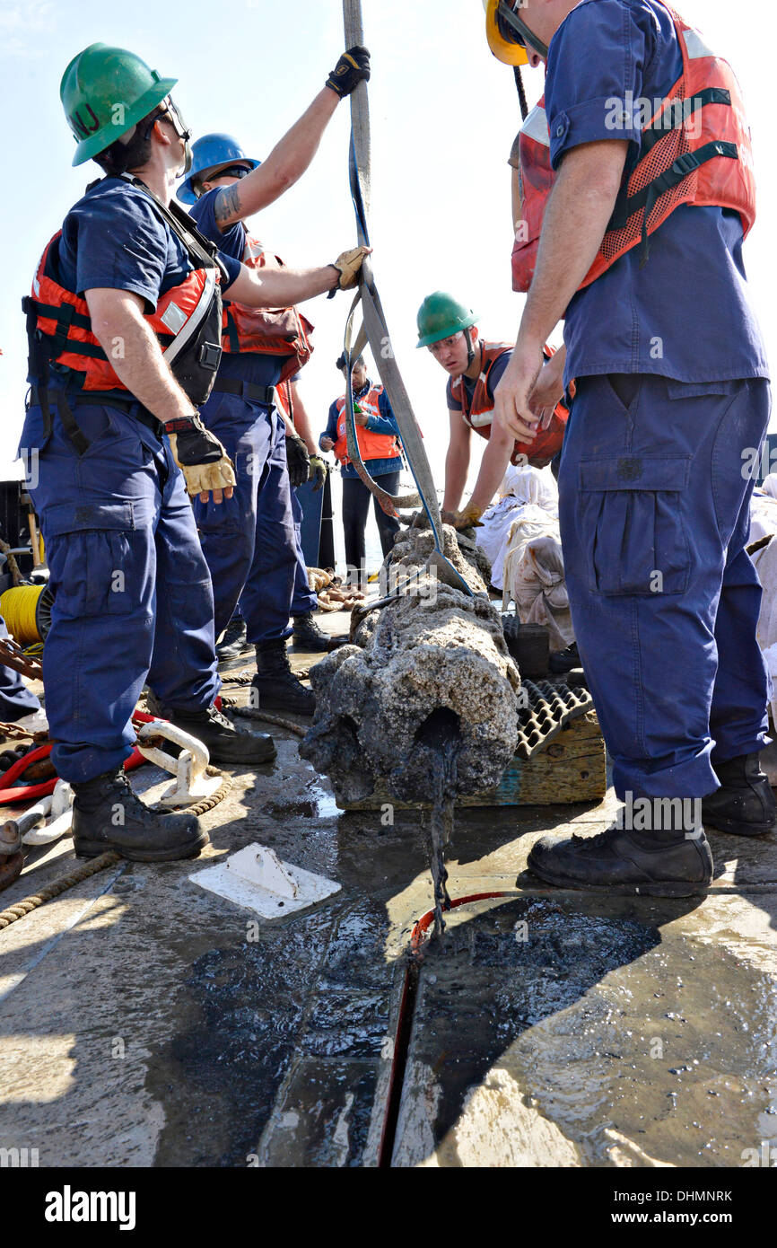 The crew of the Coast Guard Cutter Smilax work with the North Carolina Department of Cultural Resources to recover five cannons and artifacts from the wreck of the Queen Anne's Revenge October 28, 2013 in Beaufort Inlet, NC. The Queen Anne's Revenge was the ship of the pirate Edward Teach, better known as Blackbeard. Stock Photo