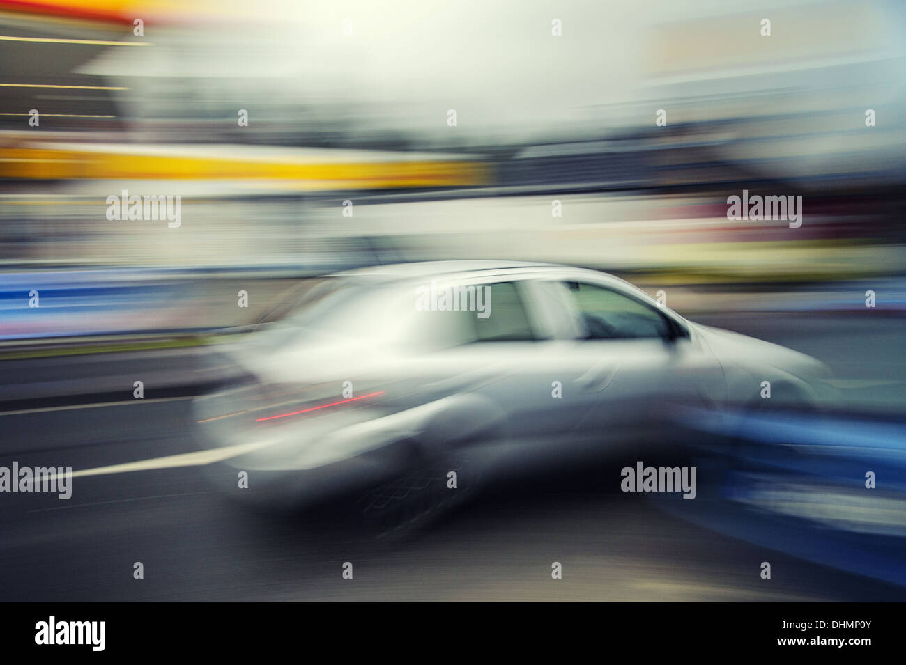 Car runs at excessive speeds in a built-up Stock Photo