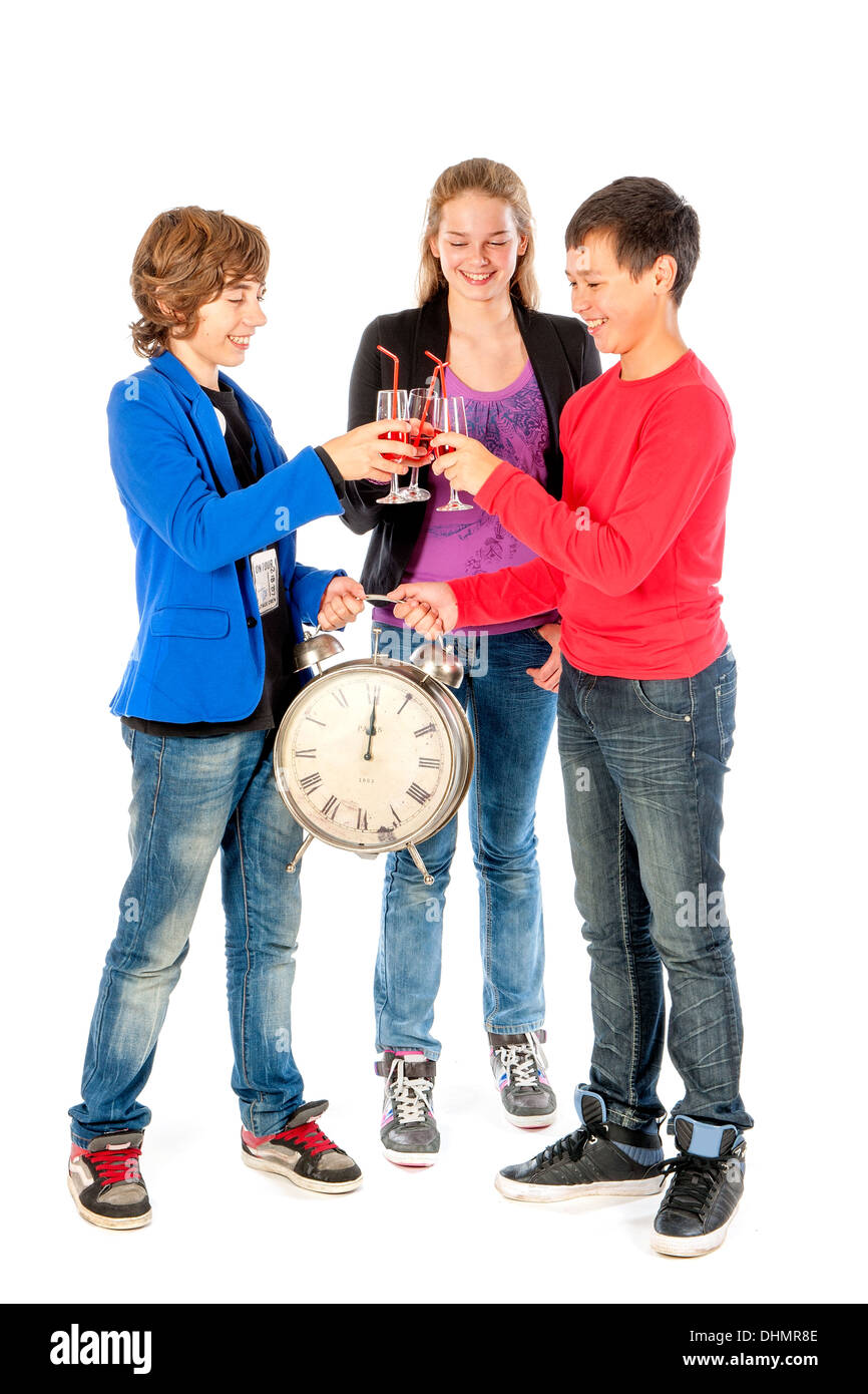 Cheers! on twelve o'clock on new year's eve, three teenagers celebrating New Year Stock Photo
