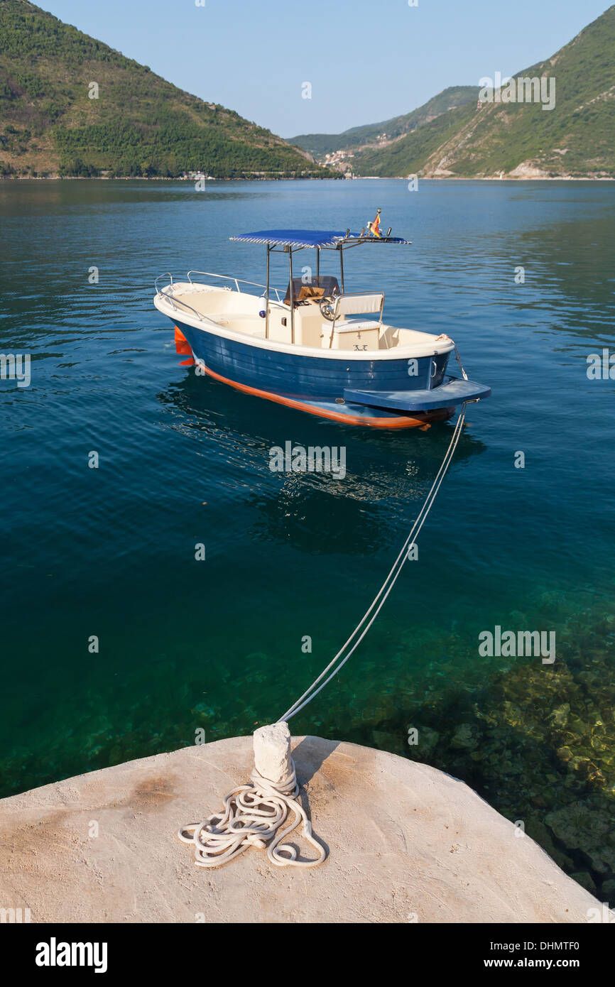 Small pleasure boat floats moored in Perast town, Kotor Bay, Montenegro Stock Photo