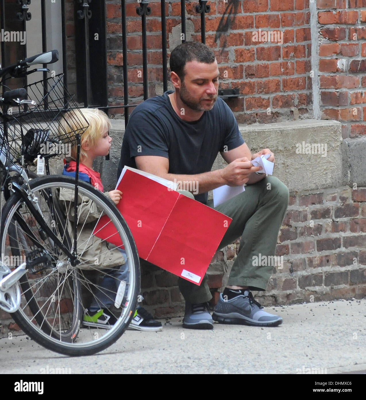 Liev Schreiber reads to his son outside his school in Manhattan New York City, USA - 04.05.12 Stock Photo