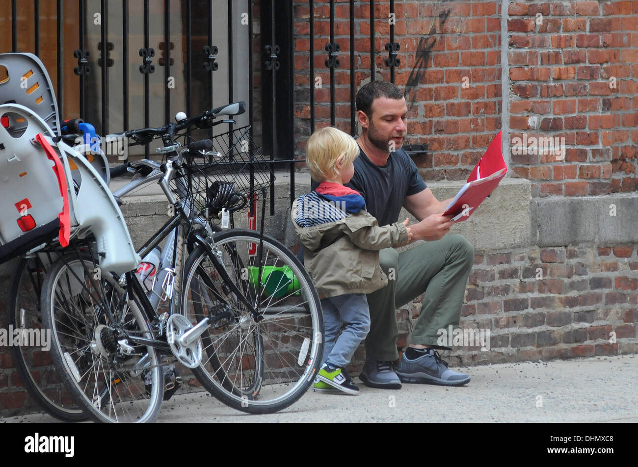 Liev Schreiber reads to his son outside his school in Manhattan New York City, USA - 04.05.12 Stock Photo