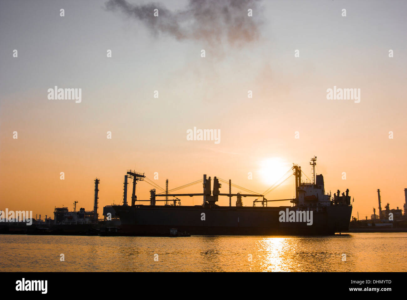Oil refinery view and freighter with Sunrise Stock Photo