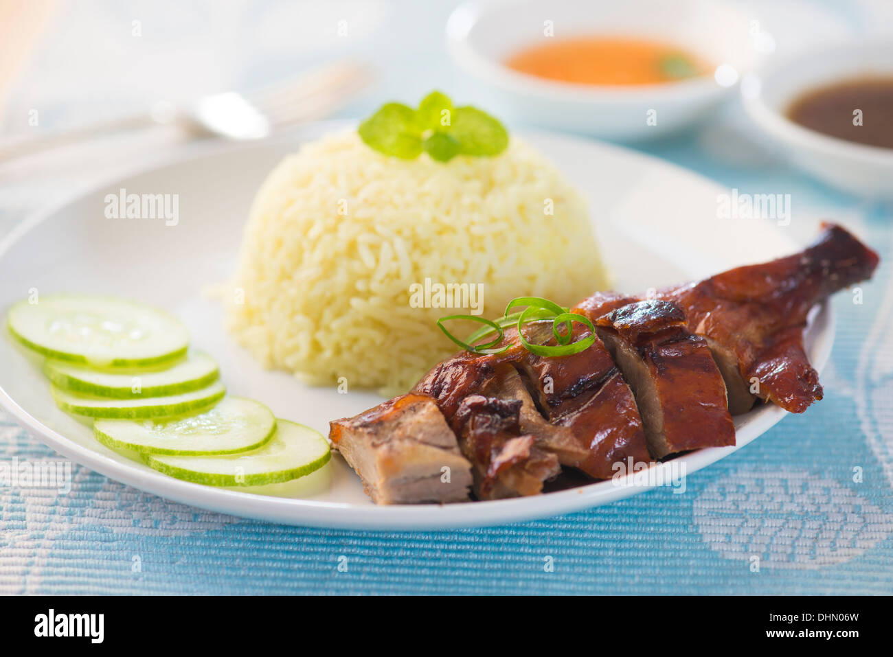Roasted duck, Chinese style, served with steamed rice on dining table