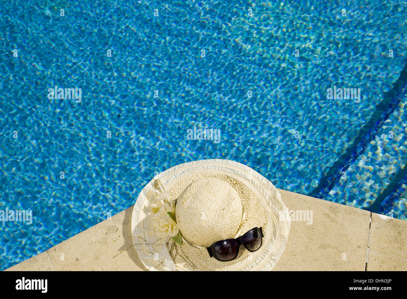 The straw hat lies on the brink of pool Stock Photo - Alamy