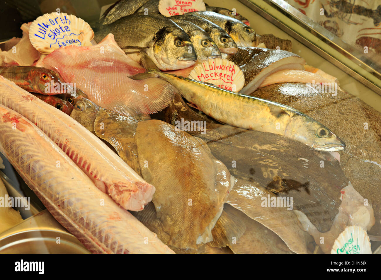 Fresh fish on display in a fishmonger's window in Lulworth Cove, Dorset Stock Photo