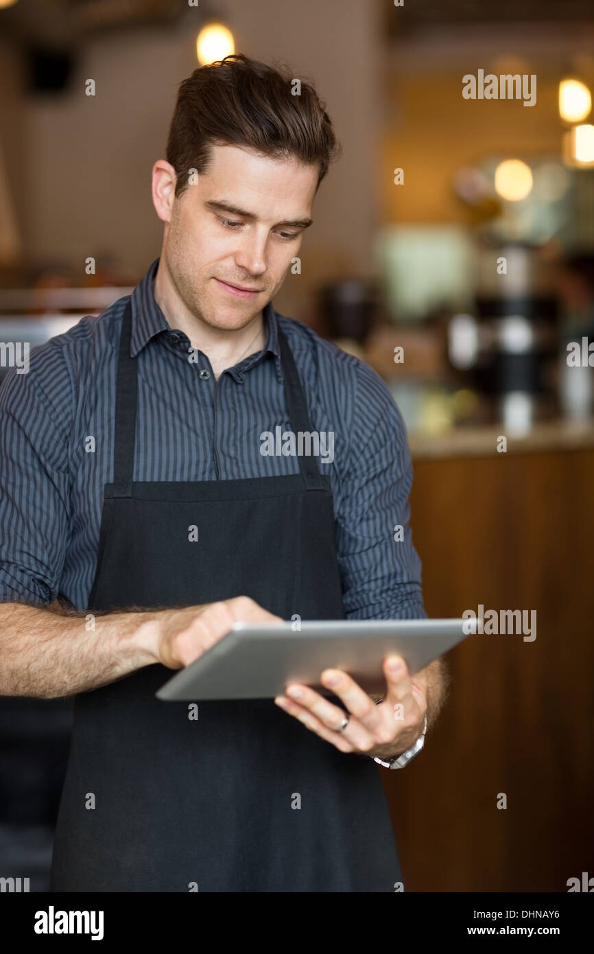 Male Owner Using Digital Tablet Stock Photo