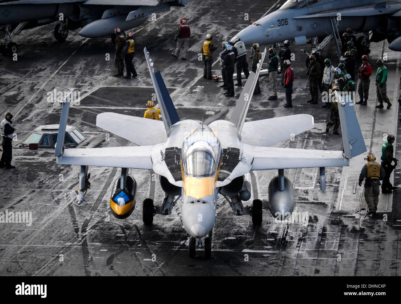 A U.S. Navy F/A-18C Hornet aircraft taxis on the flight deck of the aircraft carrier USS Nimitz during flight operations November 6, 2013 in the Mediterranean Sea. Stock Photo