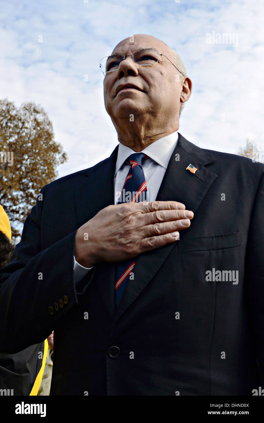 Former Secretary of State General Colin Powell stands for the pledge as he looks toward the Vietnam Veterans Memorial Wall during Veterans Day observances November 11, 2013 in Washington, DC. Thousands of people gathered at the wall for a Veterans Day event to remember those who died in the conflict and to honor all who served. Stock Photo