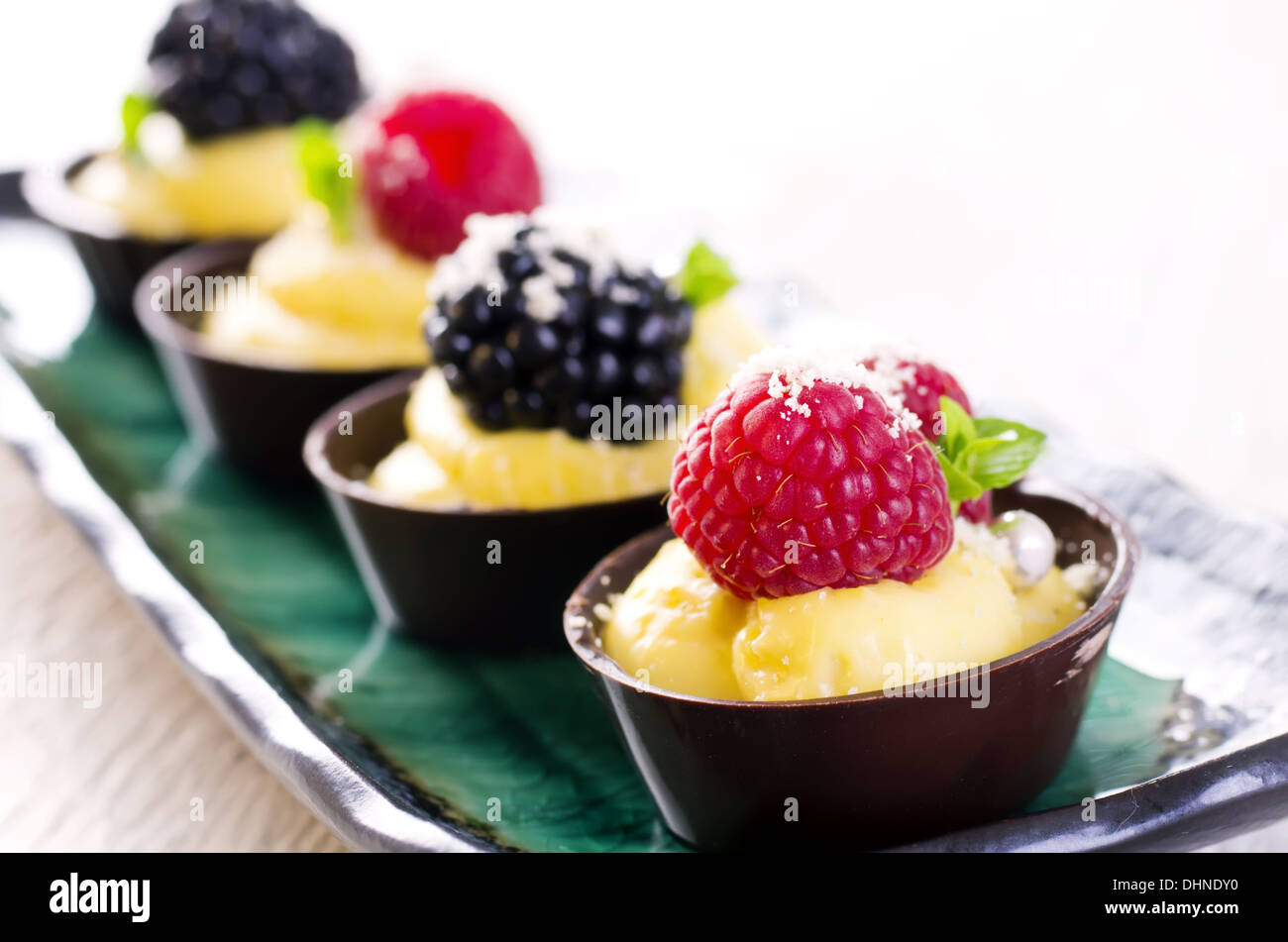 chocolate tartlets with custard and berries Stock Photo