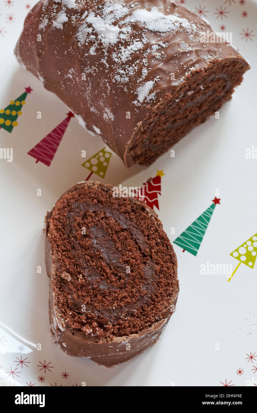 Marks & Spencer Extremely Chocolatey Yule Log cut up on festive plate Stock Photo