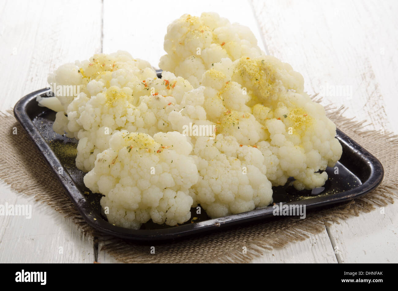 warm cauliflower with spice mix in an old black pan Stock Photo