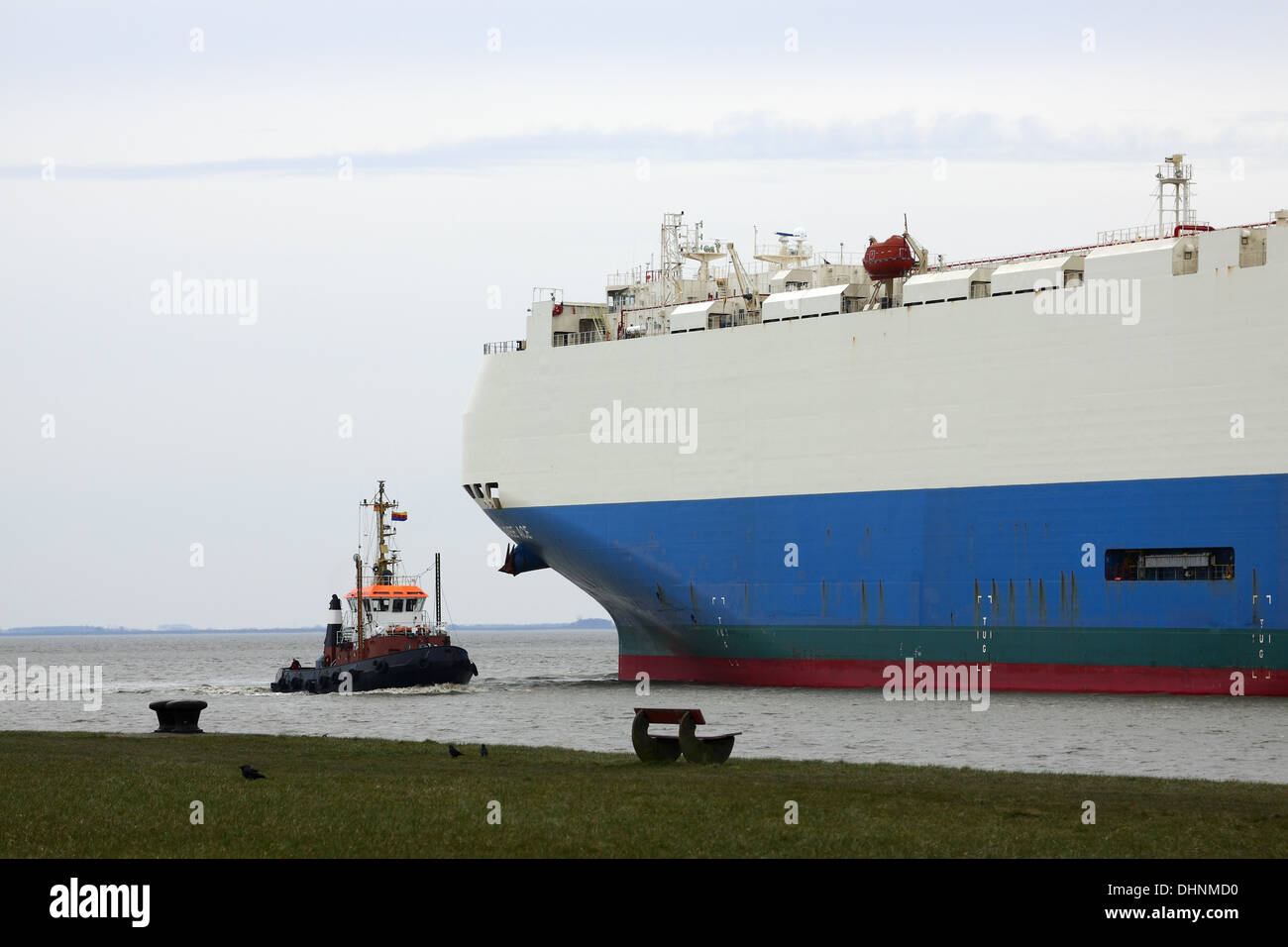 Tugs and overseas ferry Stock Photo