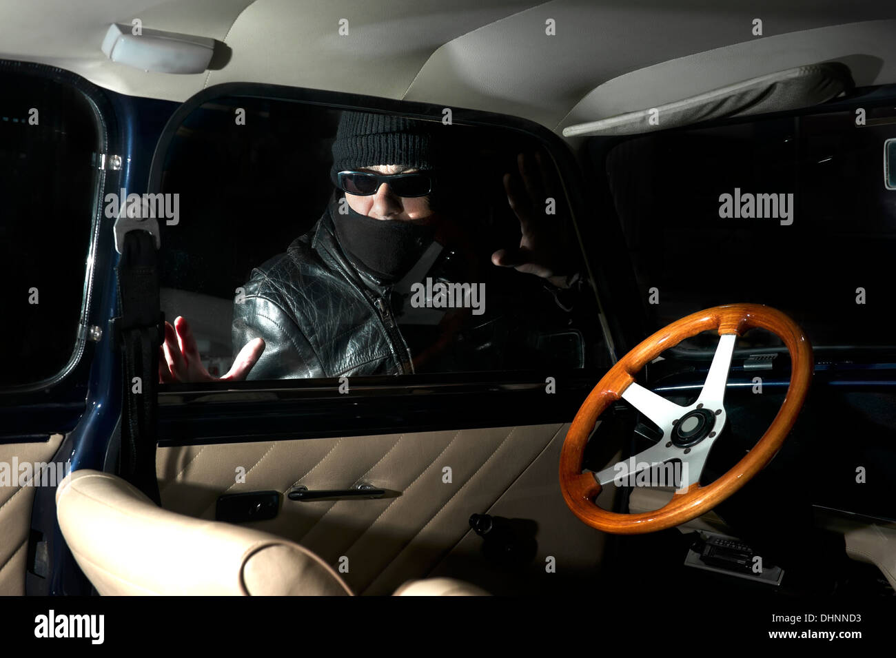 Thief trying to steal a car Stock Photo