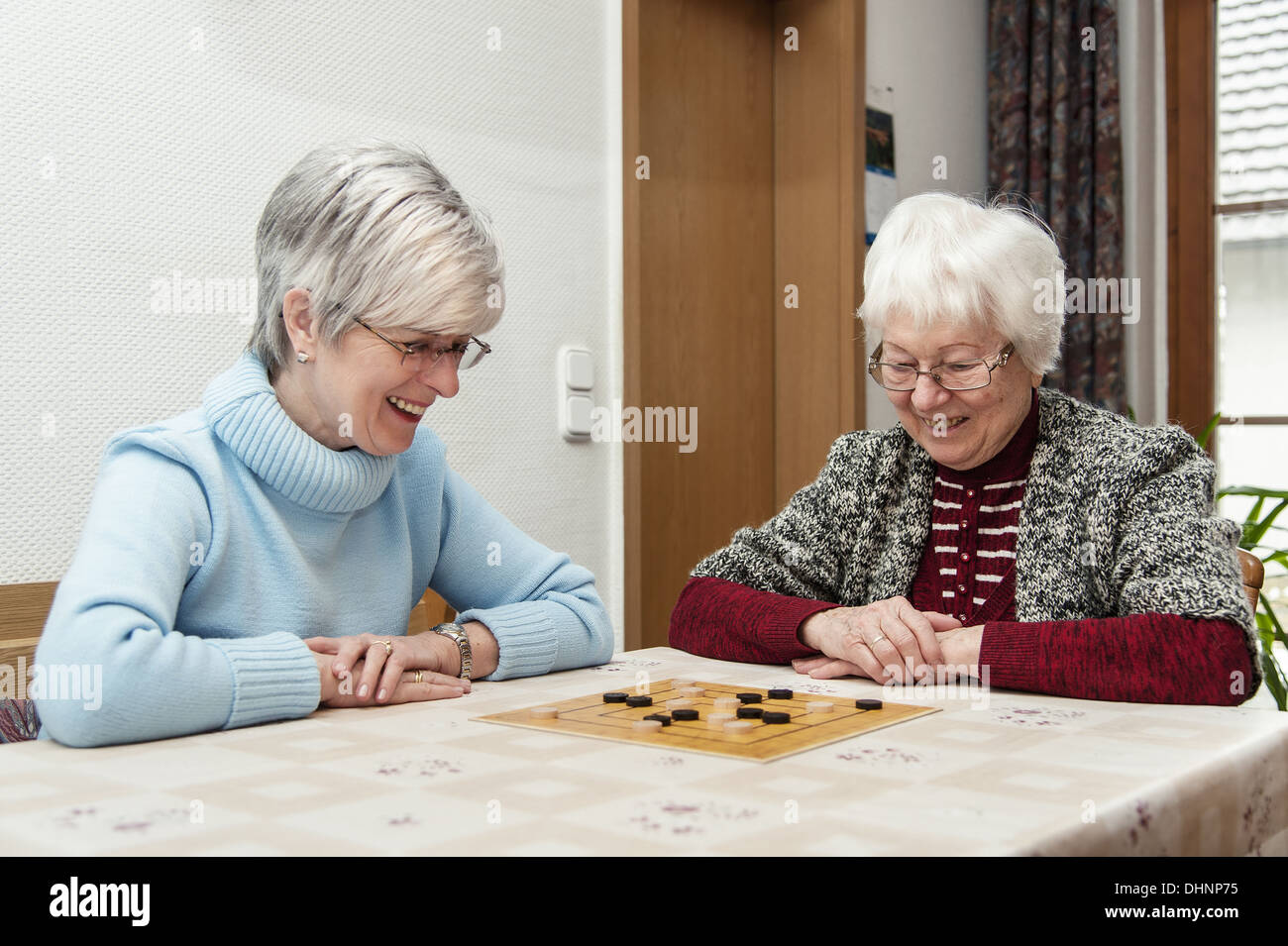 2 seniors play the board game together mill Stock Photo Alamy