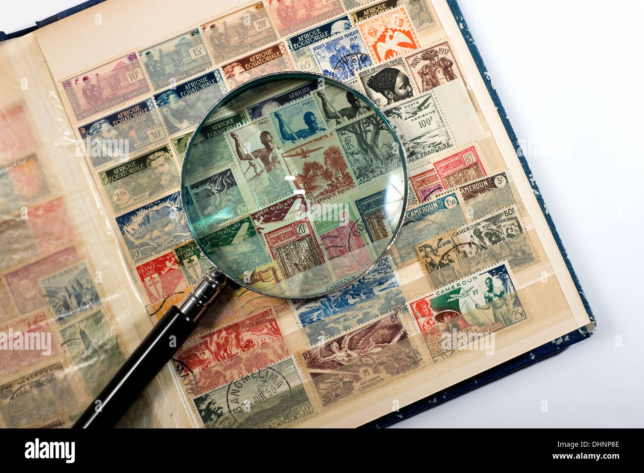 Postage stamp collection album with a magnifying glass on it Stock Photo