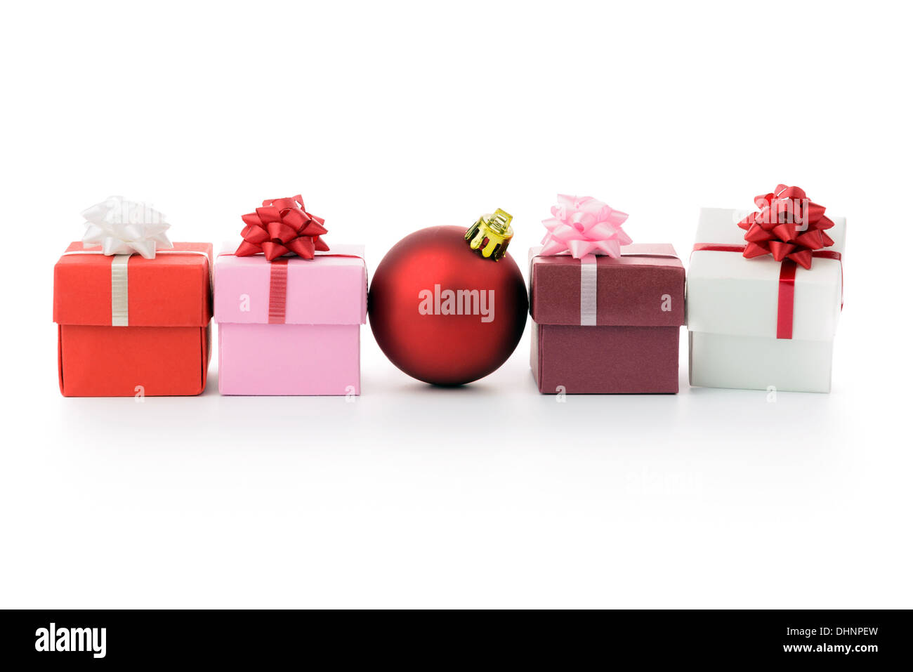 Multi color gift boxes and Christmas bauble in a row Stock Photo