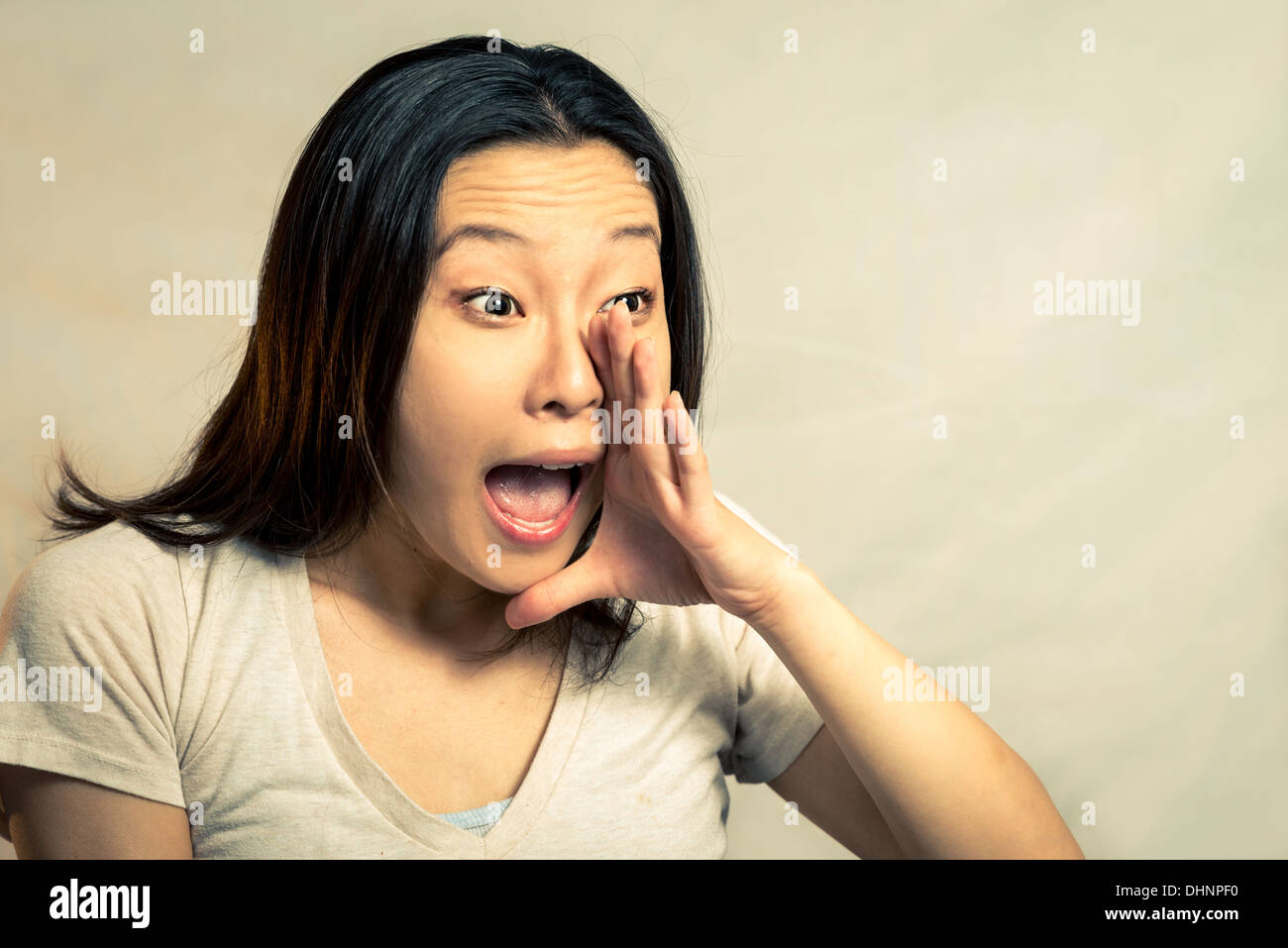 Young woman shouting, with fashion tone and background Stock Photo