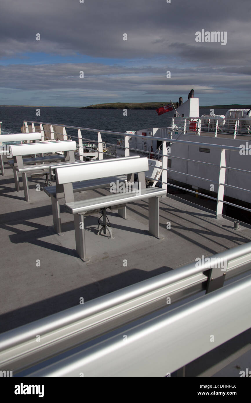 Islands of Orkney, Scotland. An empty outside passenger deck on the MV Pentalina with the Orkney Islands in the background. Stock Photo