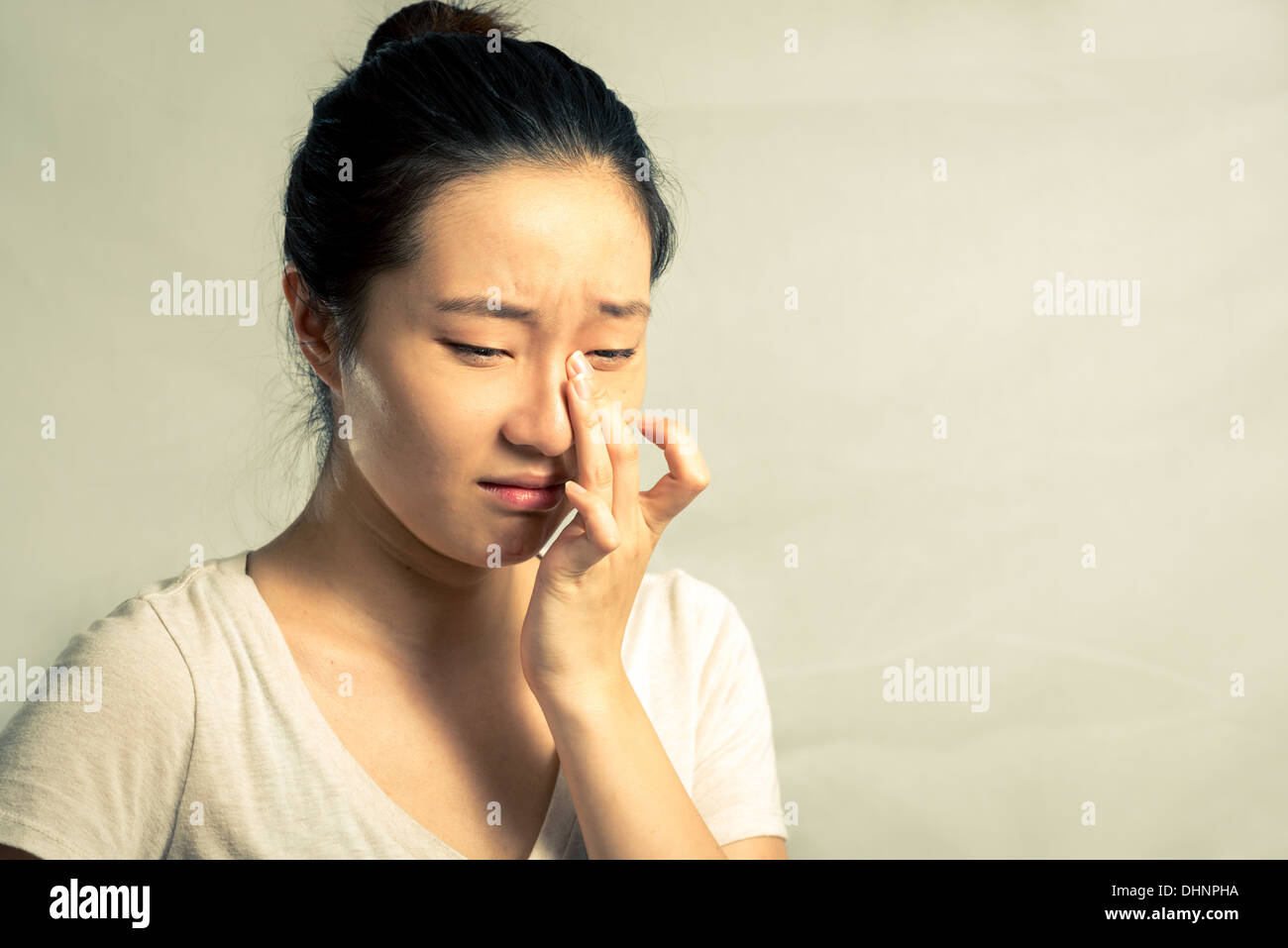 Portrait of young woman crying desperately, with fashion tone and background Stock Photo