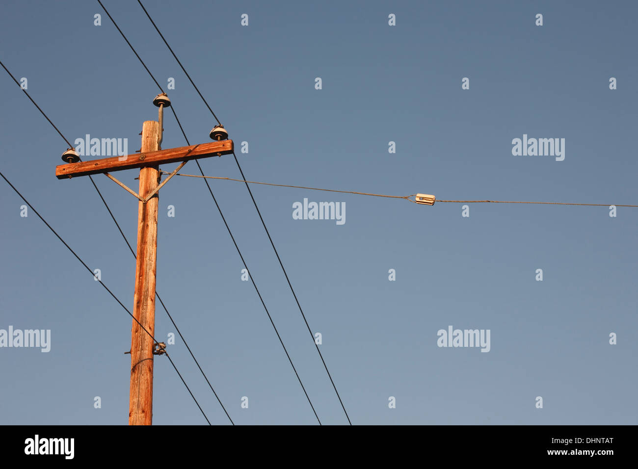 Electrical pole and clear blue sky Stock Photo - Alamy