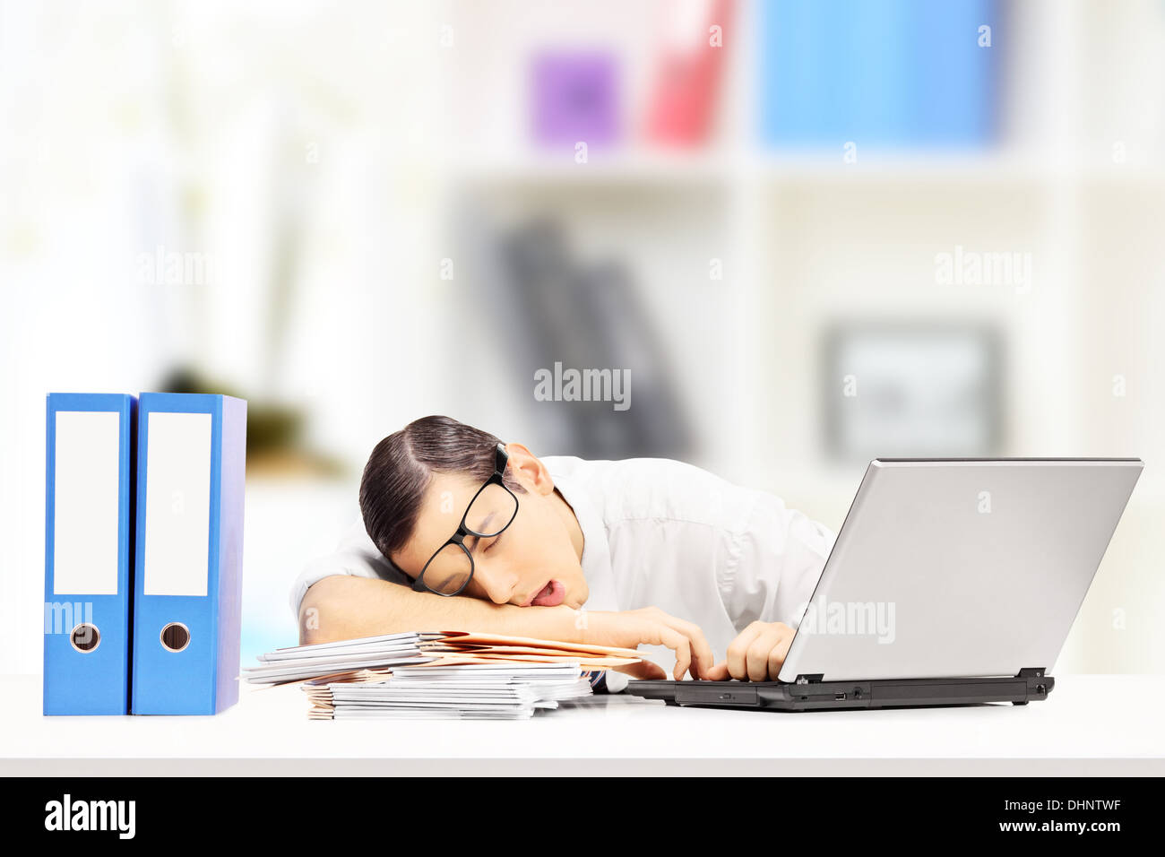 Exhausted office worker is sleeping at her desk hi-res stock ...