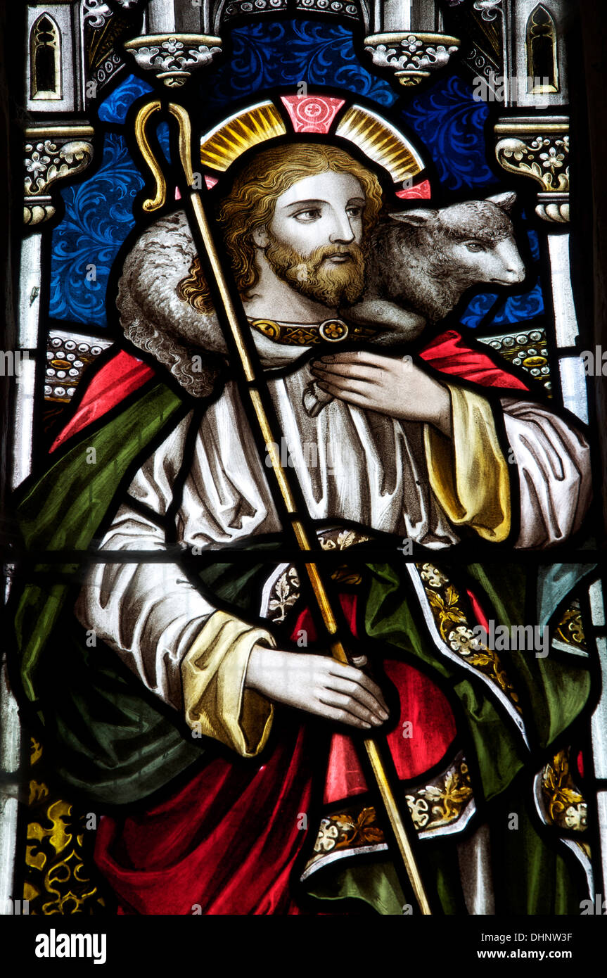 Christianity. A stained glass window depicting Jesus as a shepherd holding a crook, in the Church of St Mary the Virgin, Piddlehinton, Dorset, England. Stock Photo